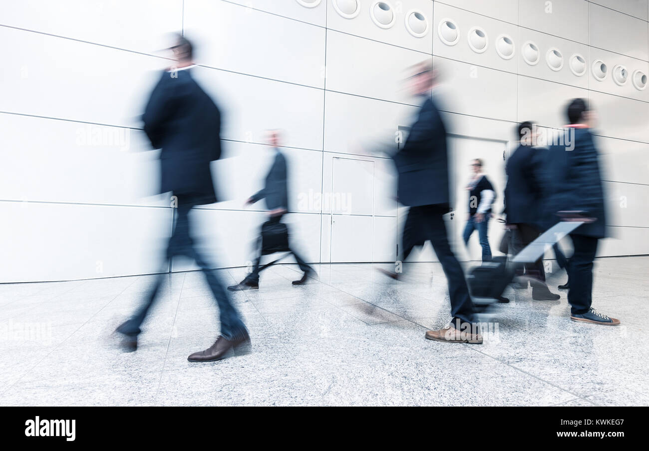 business people rushing in a corridor at a business center. Stock Photo