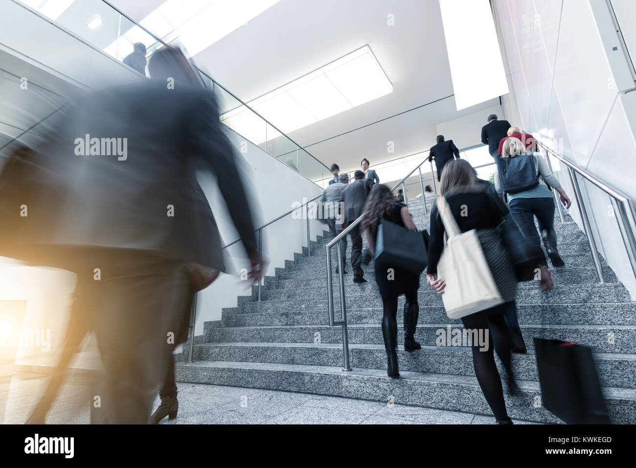 business people crowd walking up stairs at a trade show, including copy space banner. Stock Photo