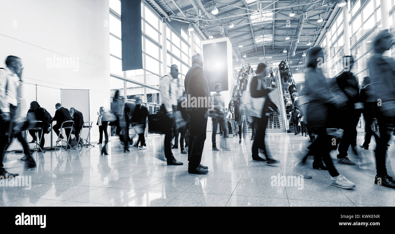 business people rushing in a lobby of a business center. Stock Photo