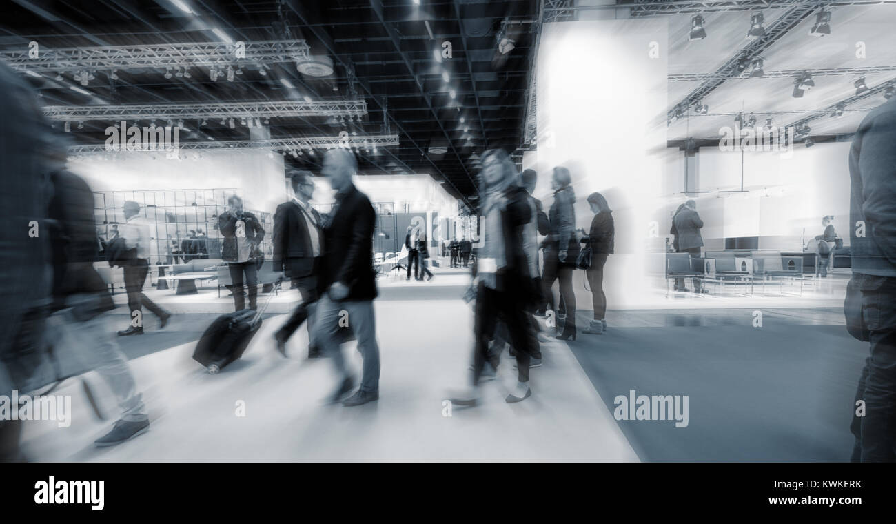 blurred people walking at trade show booths. Stock Photo