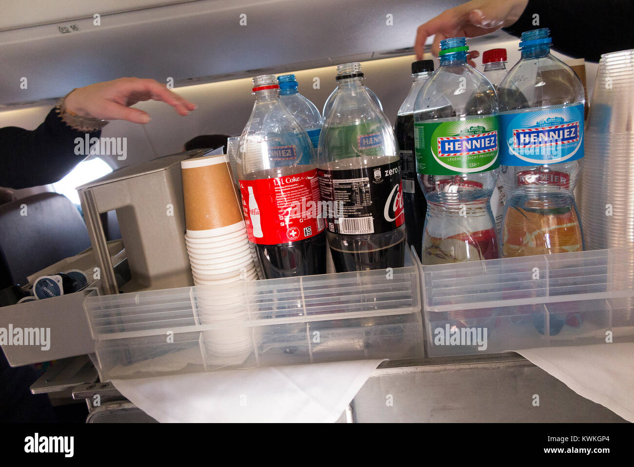 A drink trolley in the aisle on an Embraer 190 plane / aeroplane /  airplane. Cabin crew are serving soft drinks to passengers during a flight  Stock Photo - Alamy