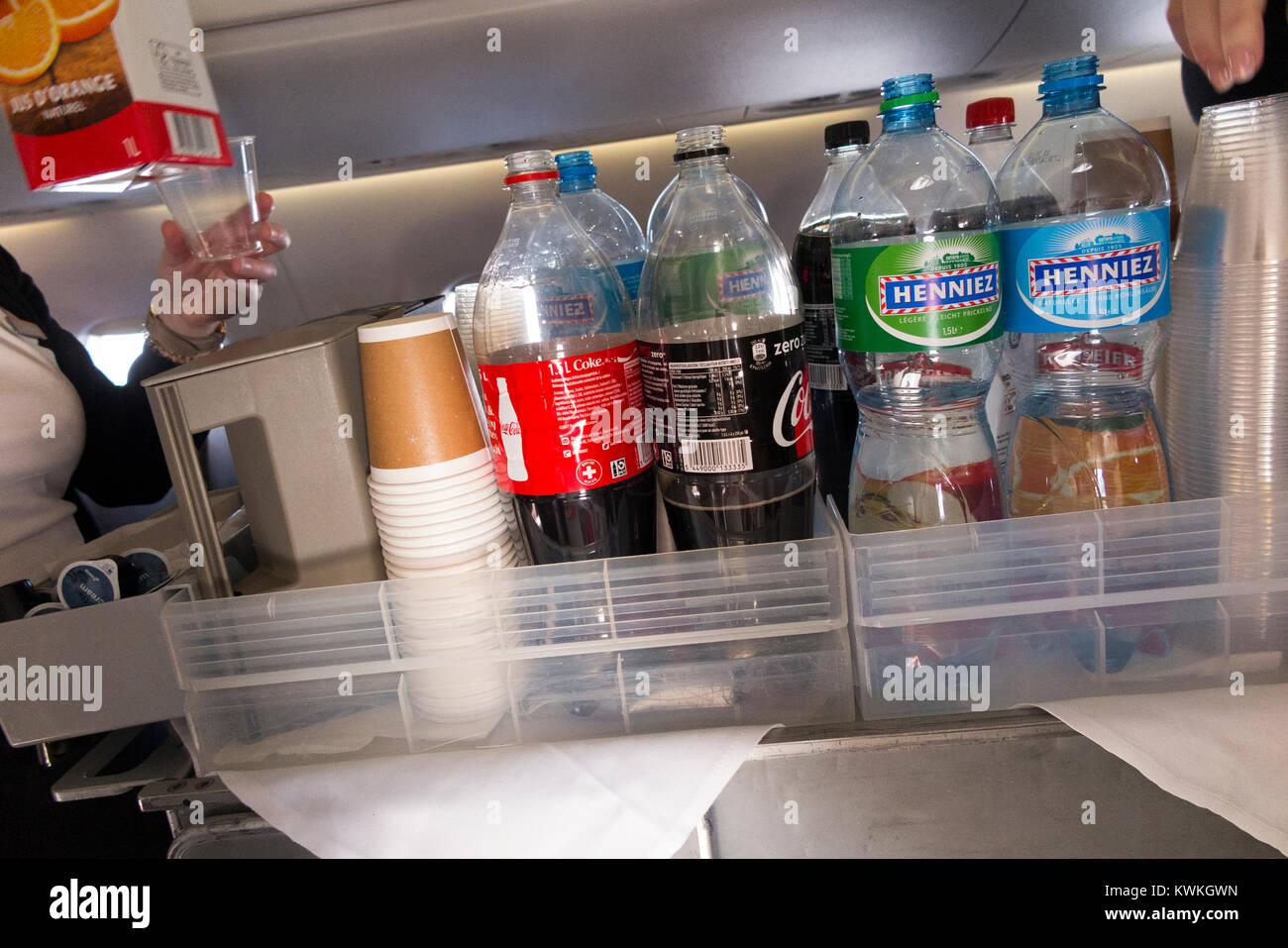 A drink trolley in the aisle on an Embraer 190 plane / aeroplane