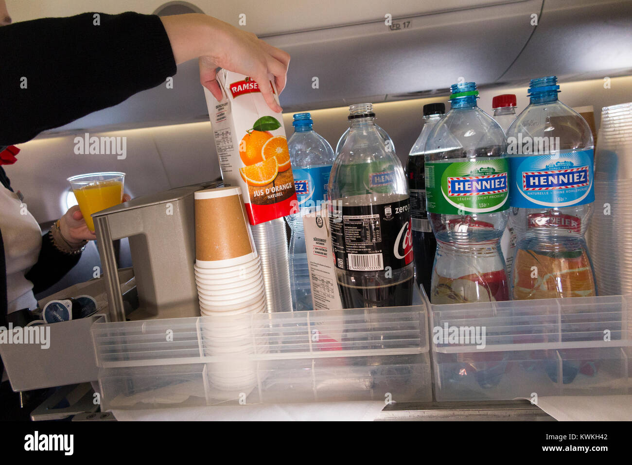 A drink trolley in the aisle on an Embraer 190 plane / aeroplane /  airplane. Cabin crew are serving soft drinks to passengers during a flight  Stock Photo - Alamy