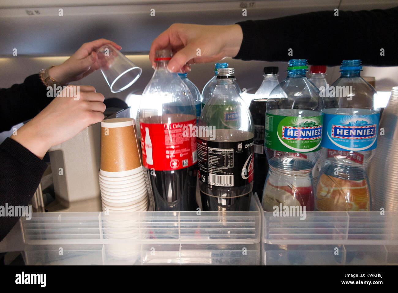 A drink trolley in the aisle on an Embraer 190 plane / aeroplane