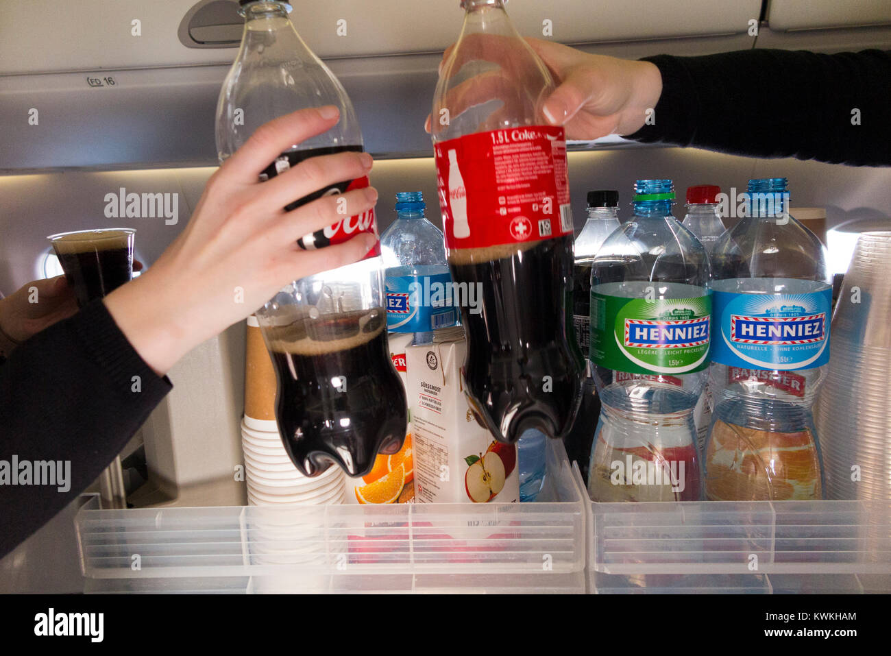 A drink trolley in the aisle on an Embraer 190 plane / aeroplane