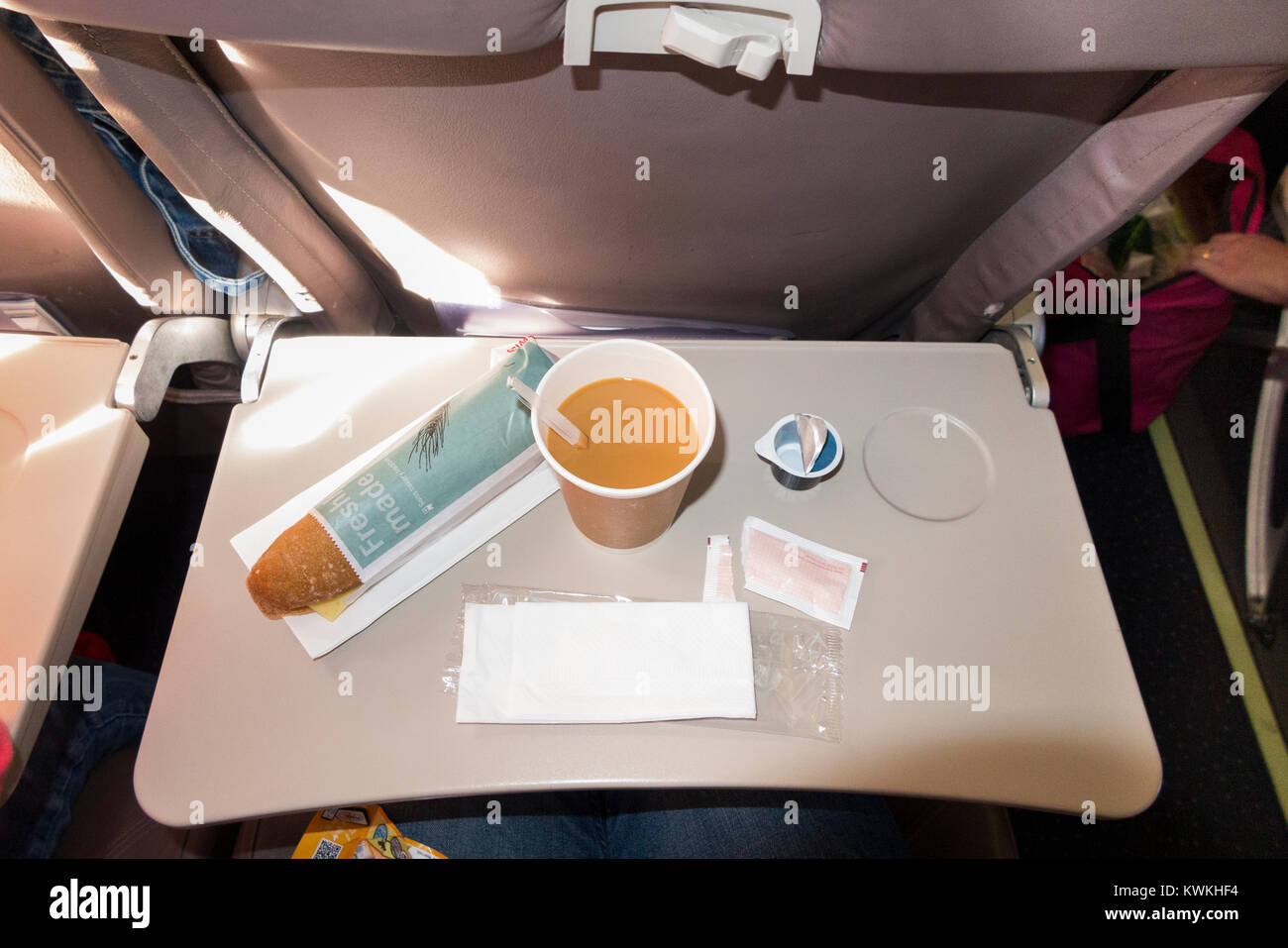Passenger seat tray table with light refreshments and ready for use by