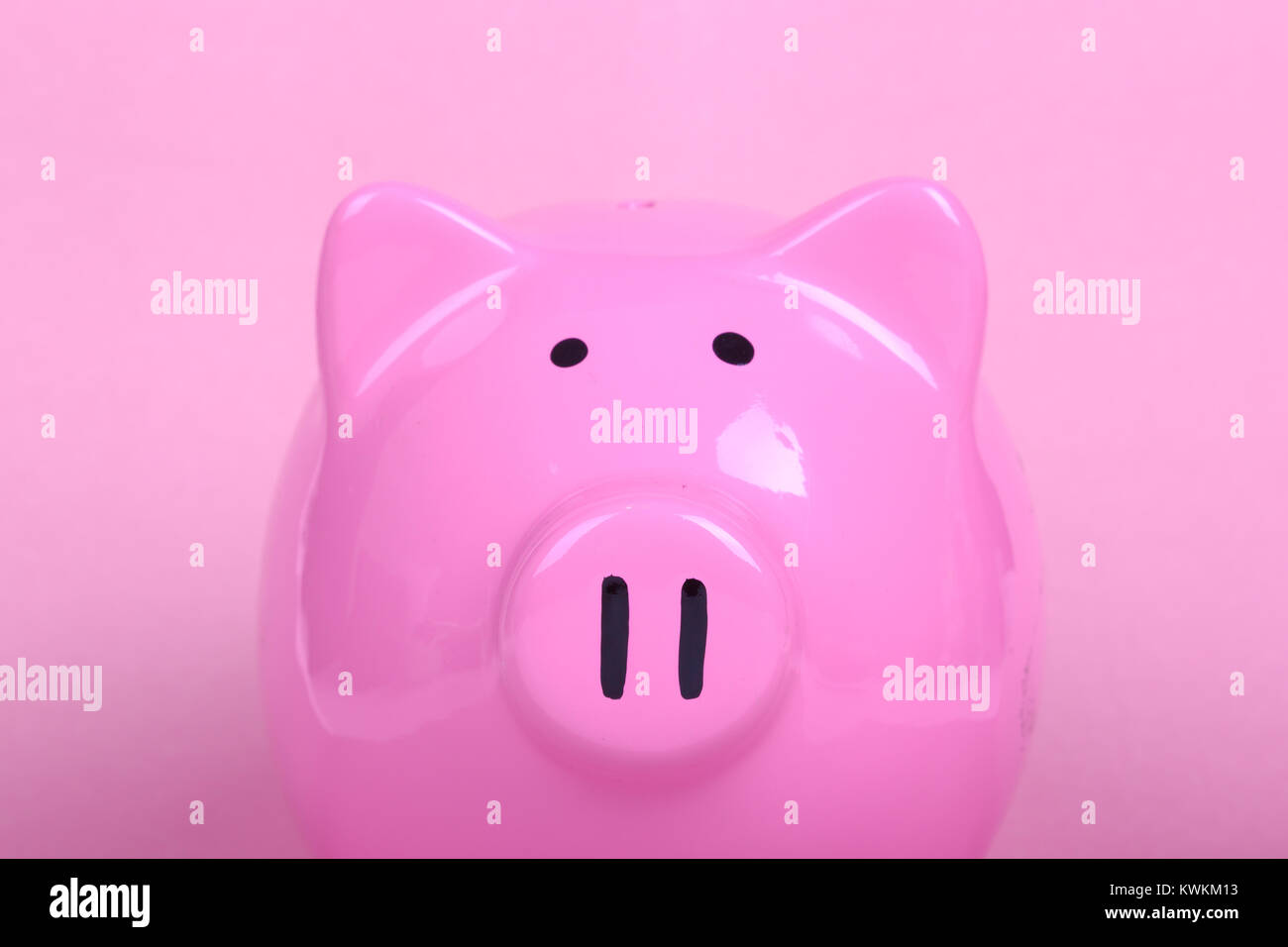 Piggy bank on soft pink background Stock Photo - Alamy
