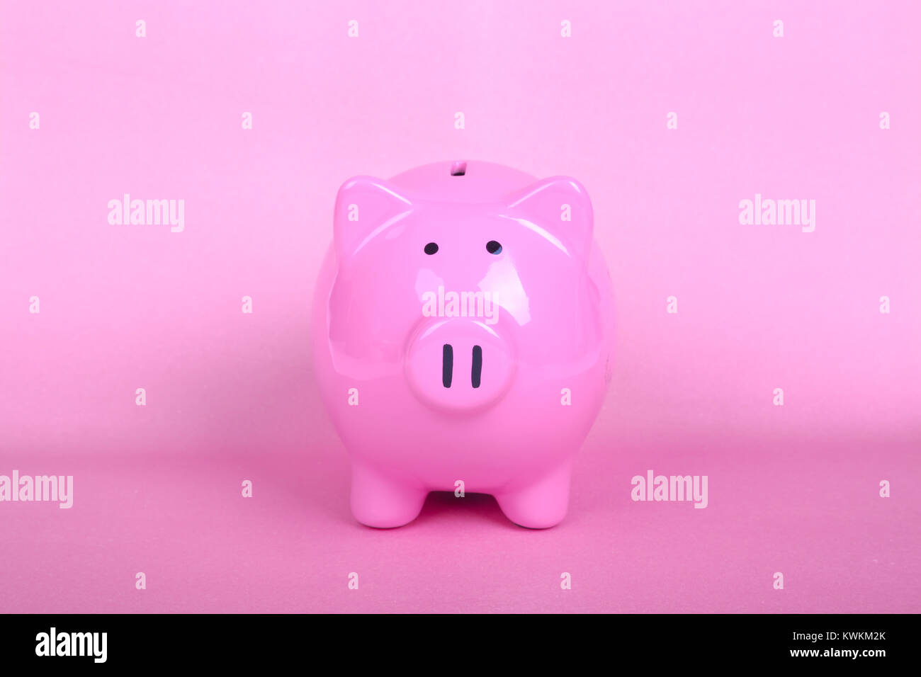 Piggy bank on soft pink background Stock Photo - Alamy