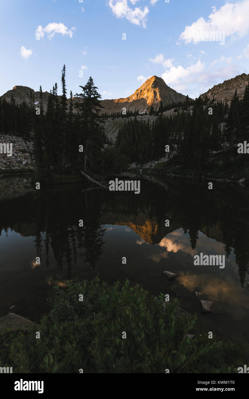 Tranquil view of lake by mountains against sky Stock Photo - Alamy