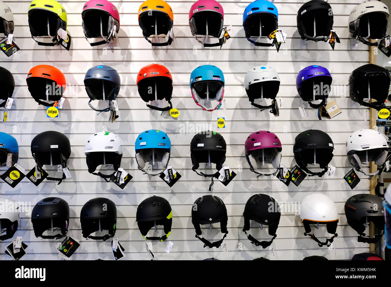 Assorted ski helmets on display in store. Stock Photo
