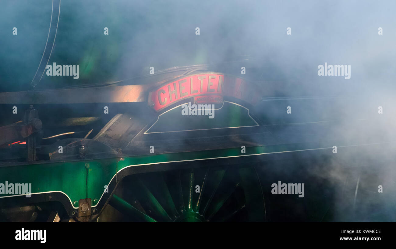 Moody view of steam engine nameplate - 'Cheltenham' - through clouds of steam with high key lighting Stock Photo