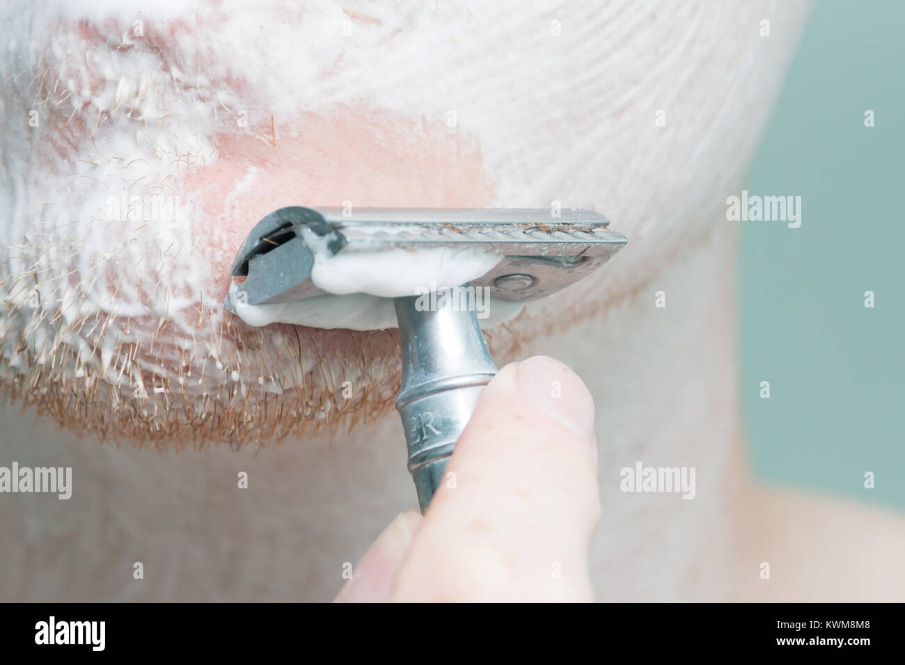 Close up shaving a face Stock Photo