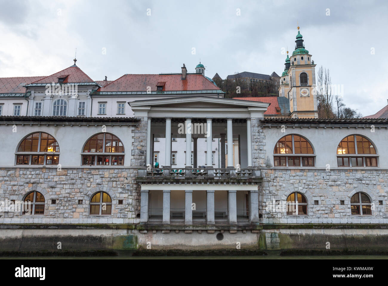 Central Market of Ljubljana, capital city of Slovenia, taken during a cloudy rainy day, with the Ljubljanica river on foreground. This part of the old Stock Photo