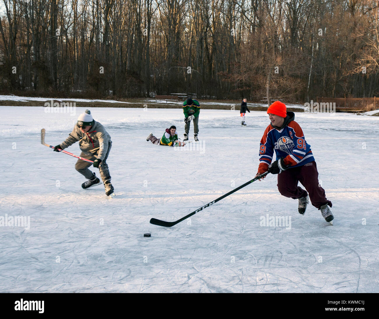 Boys playing ice hockey on a frozen pond Stock Photo Alamy