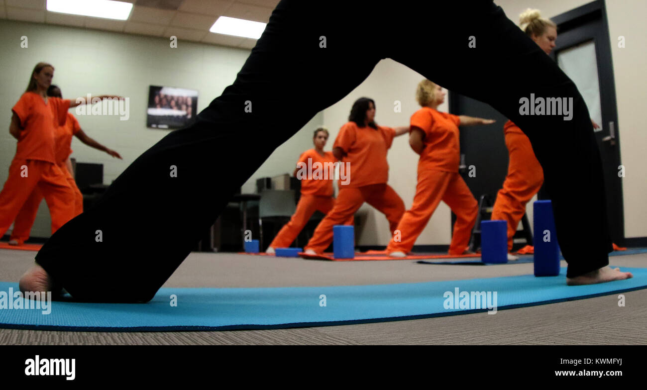 Davenport, Iowa, USA. 11th Oct, 2017. Instructor and volunteer Joan Marttila teaches yoga to female Scott County Jail inmates in the library of the jail, Wednesday, October 11, 2017, during a jail yoga class held at the Scott County Jail. Credit: John Schultz/Quad-City Times/ZUMA Wire/Alamy Live News Stock Photo