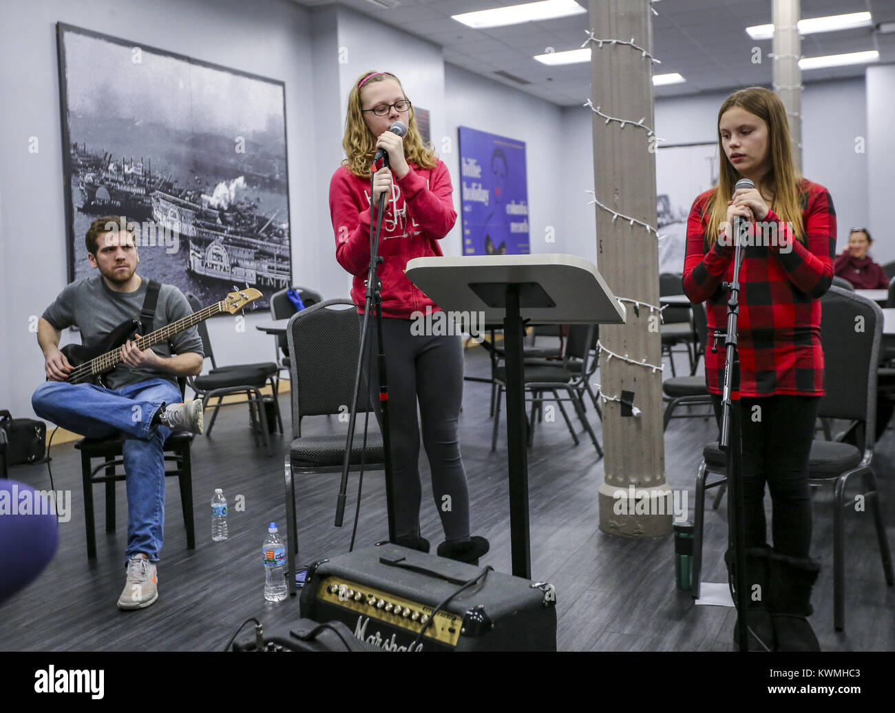 Davenport, Iowa, USA. 27th Dec, 2016. Vocalists Alexa Mueller, 11, center, of Hampton, and Anastashia Burmeister, 12, right, of Davenport practice with bassist Tommy Tallman of Davenport and the rest of their group at the River Music Experience building in Davenport on Tuesday, December 27, 2016. The annual Winter Blues program features vocal and instrumental workshops as well as a concentration on blues composition and improvisation. Sessions are open to area musicians aged 8-18 and run Monday through Thursday before concluding in a blues jam in the Redstone Room on Friday. (Credit Ima Stock Photo