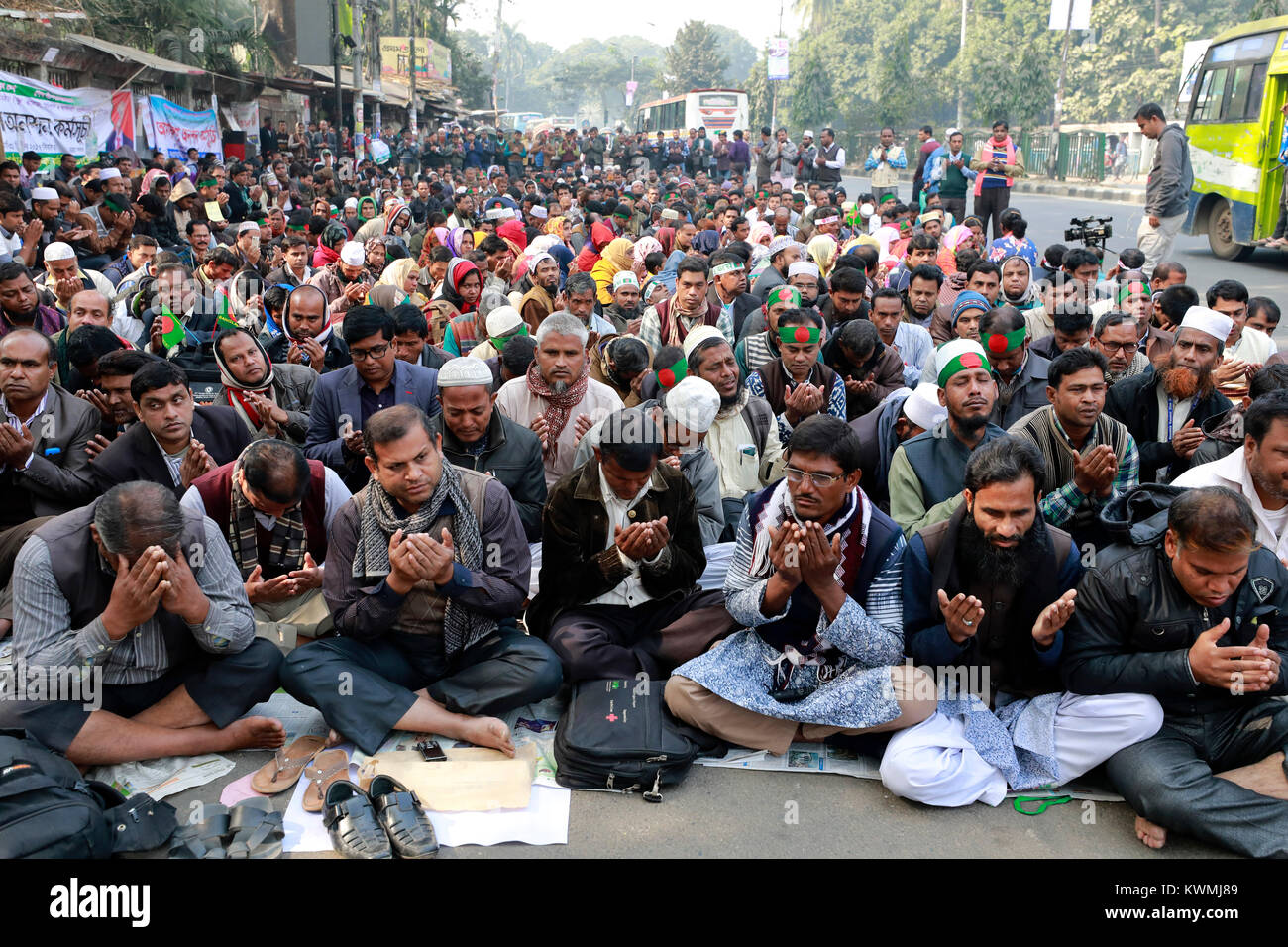 DHAKA, BANGLADESH - JANUARY 04, 2018: Teachers and employees of non-MPO educational institutions, who have been demonstrating for enlistment under the government’s MPO facilities and start fast unto death from the last 5 days, attend in a prayer in front of the Jatiya Press Club in Dhaka, Bangladesh. Stock Photo