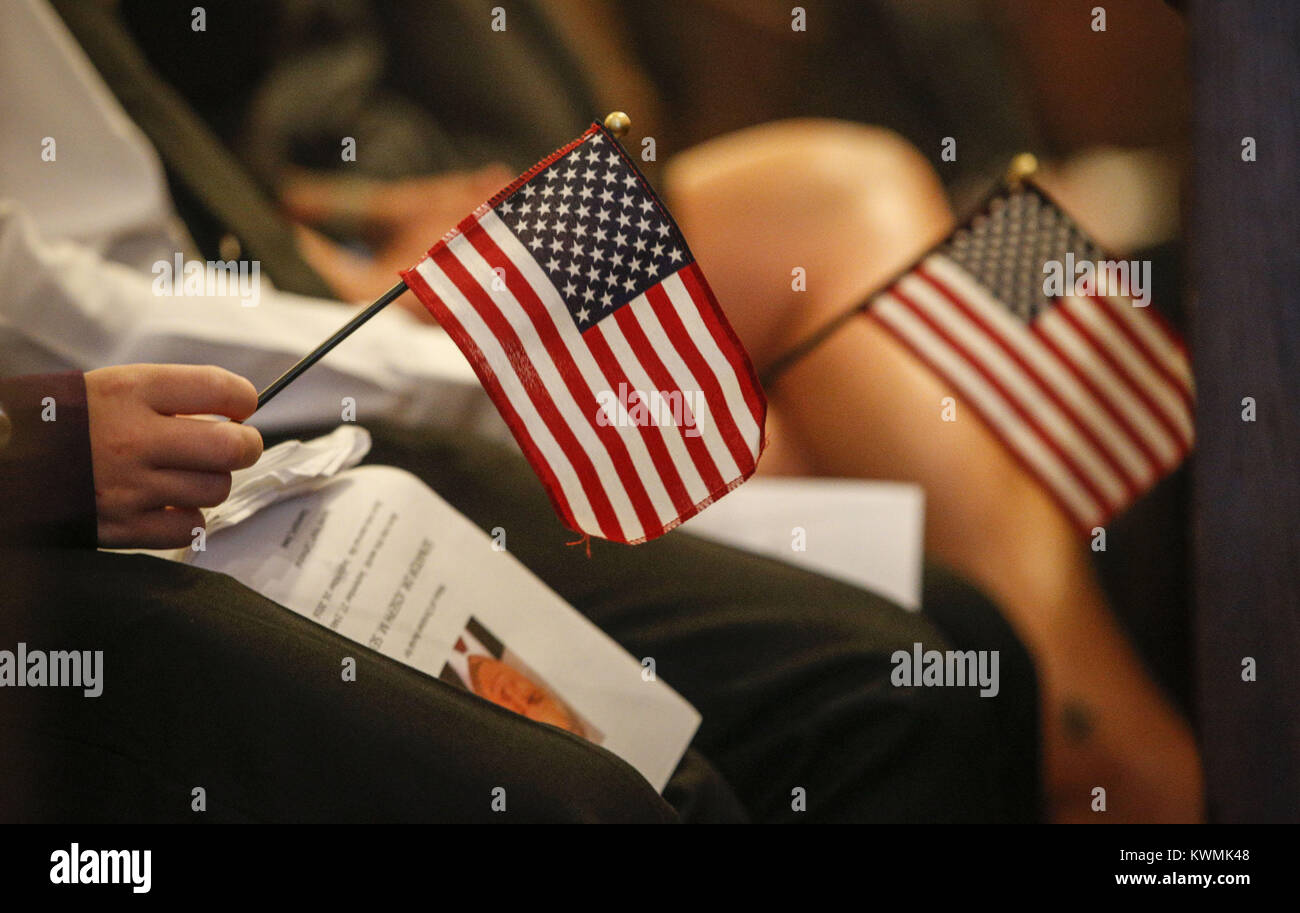 Davenport, Iowa, USA. 24th Sep, 2016. Mourners hold American flags during the funeral service of state Rep. Joe Seng at Sacred Heart Cathedral in Davenport on Saturday, September 24, 2016. The funeral for state Rep. Joe Seng, 69, who died Sept. 16 of a brain tumor was held before a number of family members, friends, and colleagues. Credit: Andy Abeyta/Quad-City Times/ZUMA Wire/Alamy Live News Stock Photo