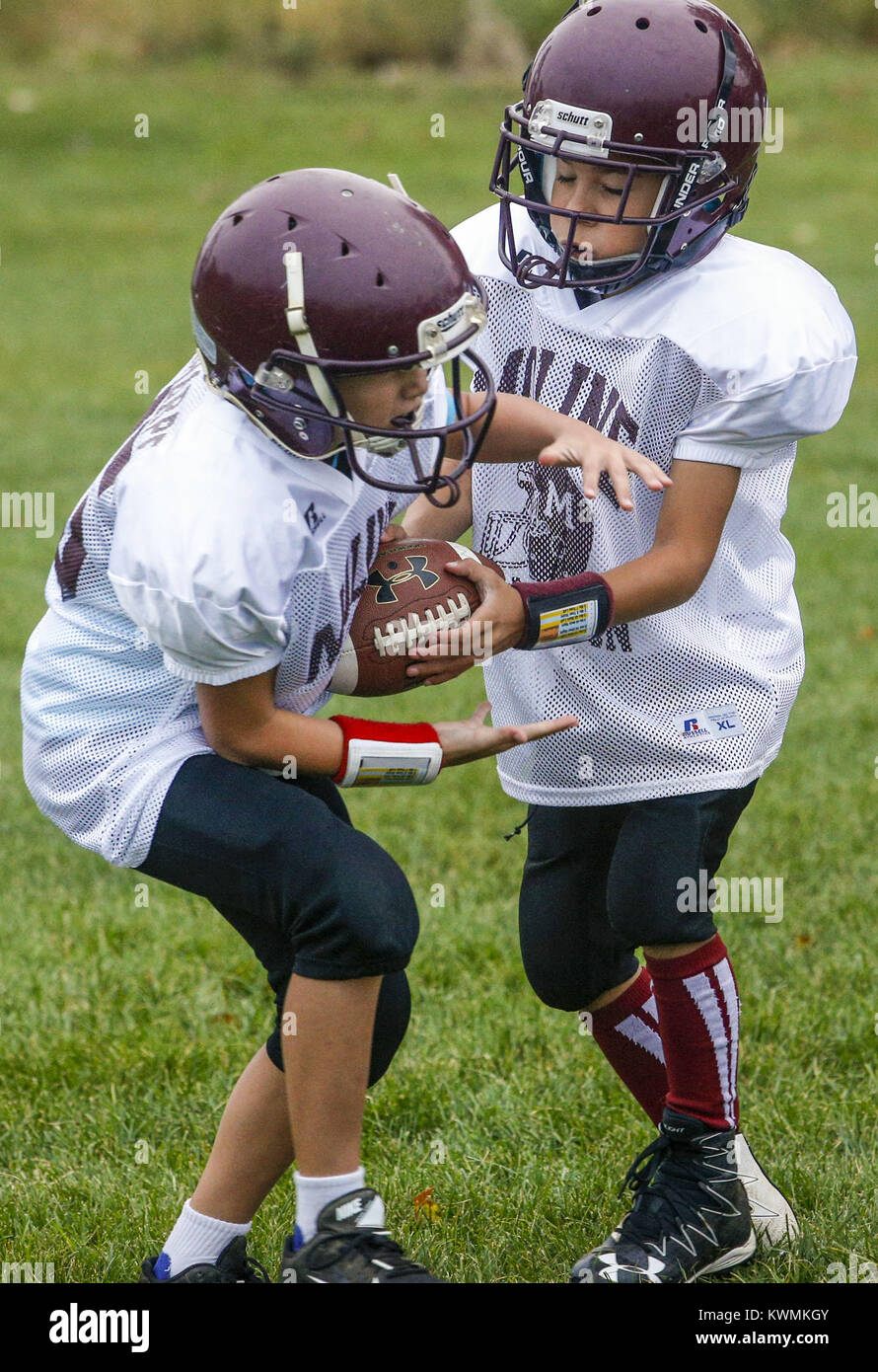 Davenport, Iowa, USA. 24th Sep, 2016. Patriots Quarterback Lyric Sterling (9) hands off to teammate Kadyn Sharpe (45) while warming up for their youth game on the freshman field at Moline High School on Saturday, September 24, 2016. The Moline Youth program Patriots faced off with the Chiefs in their third and fourth grade age group game. Credit: Andy Abeyta/Quad-City Times/ZUMA Wire/Alamy Live News Stock Photo