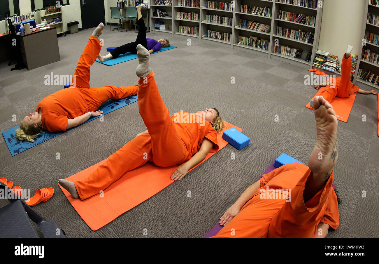 Davenport, Iowa, USA. 11th Oct, 2017. Inmates in the Scott County Jail work with yoga instructor Joan Marttila, Wednesday, October 11, 2017, on yoga positions in the library of the jail during a class. Credit: John Schultz/Quad-City Times/ZUMA Wire/Alamy Live News Stock Photo