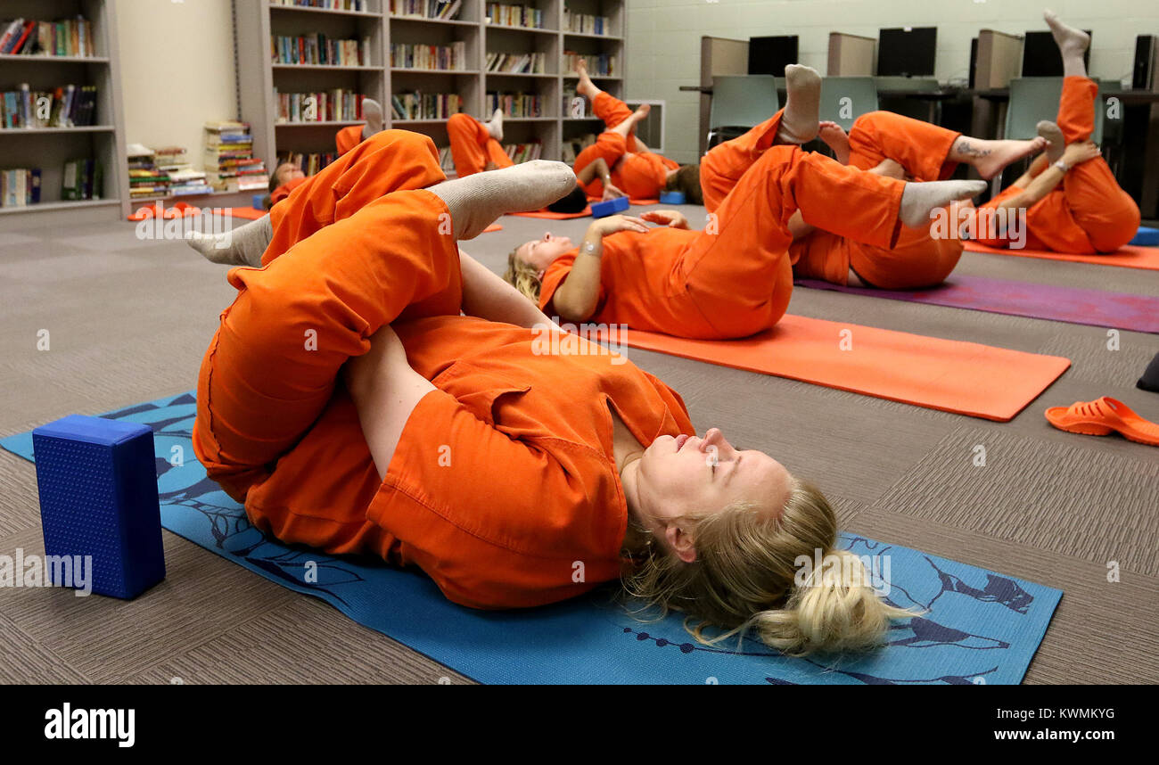 Davenport, Iowa, USA. 11th Oct, 2017. Scott County inmate Melinda Heyvaert along with six other female inmates, get into a yoga pose, Wednesday, October 11, 2017, during a jail yoga class held at the Scott County Jail. The class is taught by volunteer Joan Marttila. Credit: John Schultz/Quad-City Times/ZUMA Wire/Alamy Live News Stock Photo