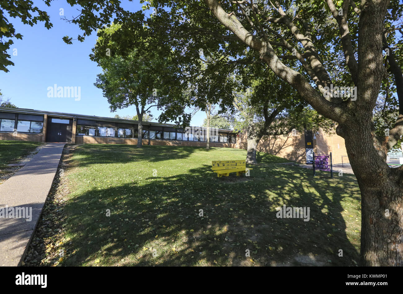 Davenport, Iowa, USA. 5th Oct, 2016. A currently underutilized grass lawn is seen at Grant Wood Elementary School in Bettendorf Wednesday, October 5, 2016. The area between the sidewalk on the left and the brick wall of the gymnasium will be an expansion of new classrooms, with the sidewalk marking the location of the hallway for the expansion. The school consistently must turn away students in its region as it already has its capacity of 375 students. The school hopes to break ground on April 1st for what is proposed to be an 18-month renovation and addition project that will ultimately Stock Photo