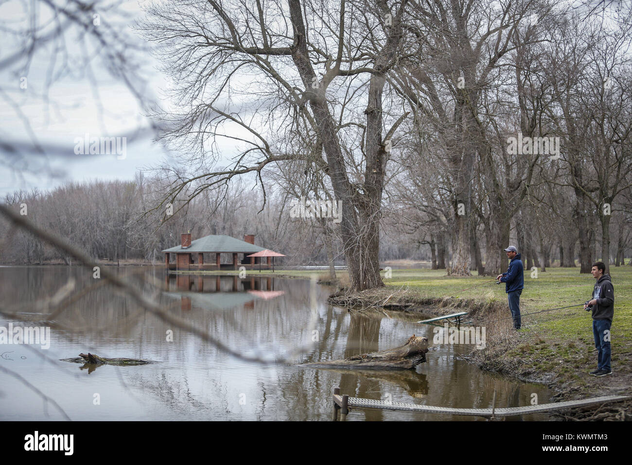 Davenport, Iowa, USA. 2nd Apr, 2017. Nathan, 16, and Jeremy Devol of Davenport stand at the edge of the water while fishing at Credit Island in Davenport on Sunday, April 2, 2017. The father and son duo spent some of the afternoon fishing at one of their local spots they make it to a few times a year. They say they sometimes are able to catch catfish, small mouth bass and perch. Credit: Andy Abeyta, Quad-City Times/Quad-City Times/ZUMA Wire/Alamy Live News Stock Photo