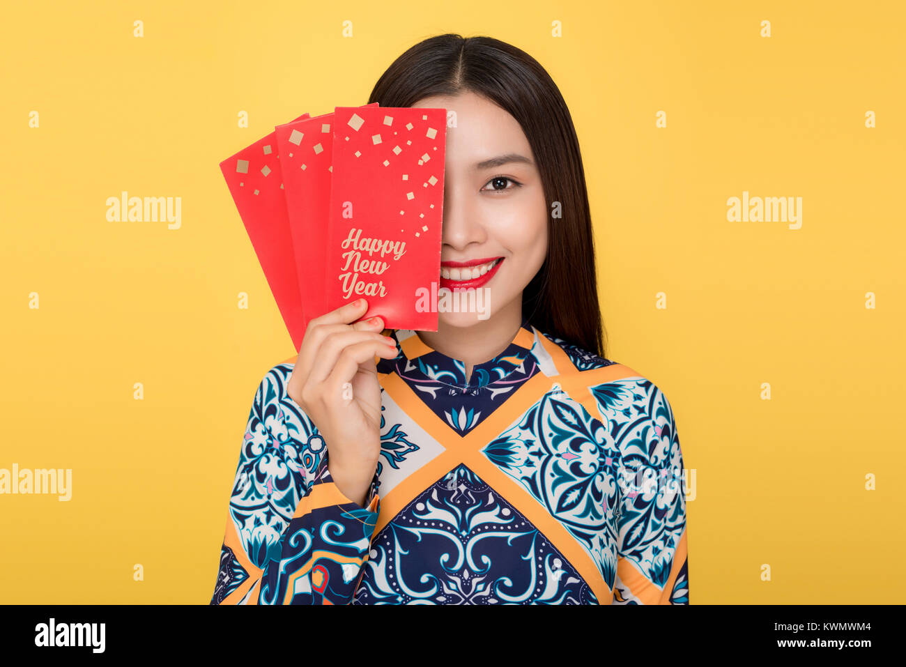 Vietnamese woman traditional festival costume Ao Da holding red money