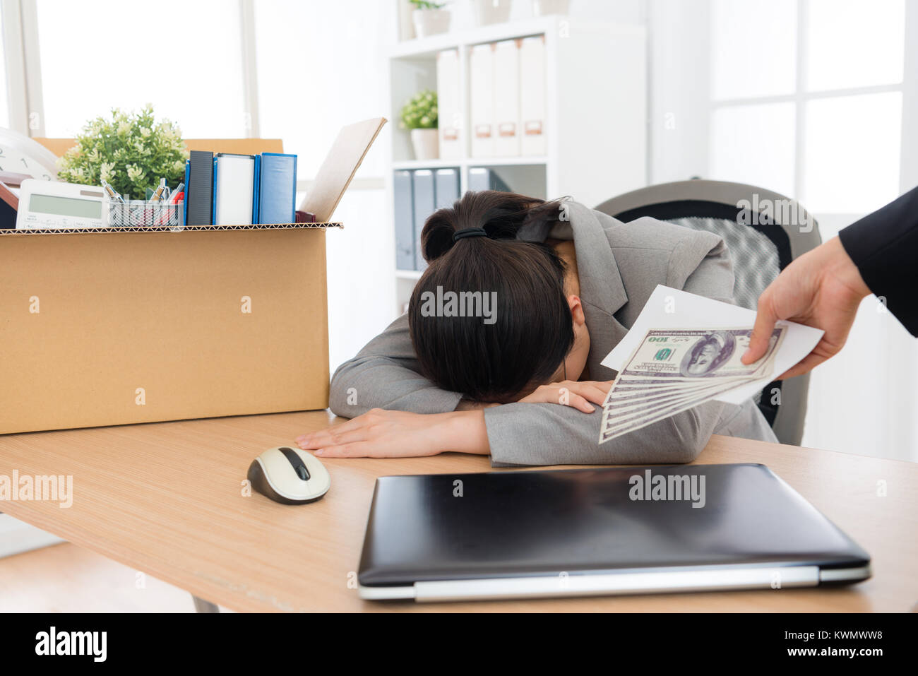sadness depression woman business worker is layoffed crying on working desk and company manager giving severance pay for her. Stock Photo