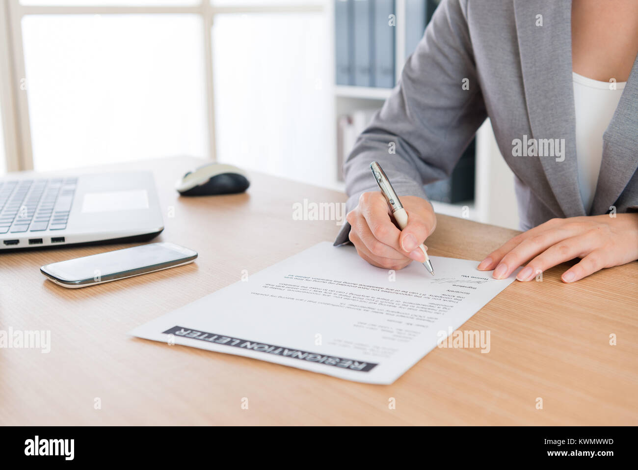 closeup of business woman decided retired from company and writing personal resignation letter explaining plan in future to application leaving. Stock Photo