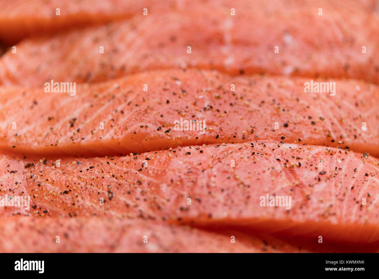 Fresh raw salmon fish fillet background with pepper Stock Photo - Alamy