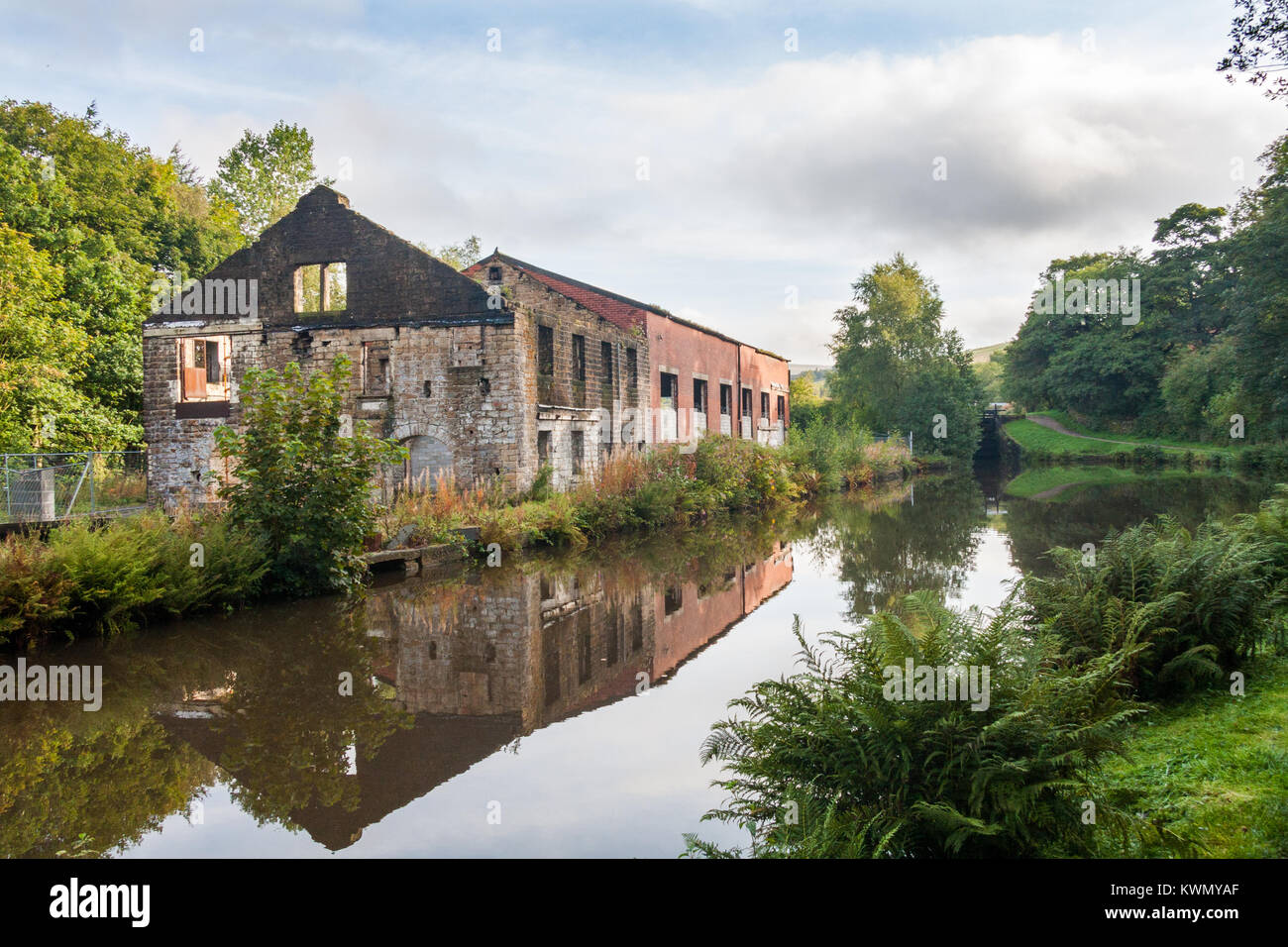 Abandoned factory warehouse on the Huddersfield narrow canal, Diggle, Saddleworth, Oldham, England, United Kingdom Stock Photo