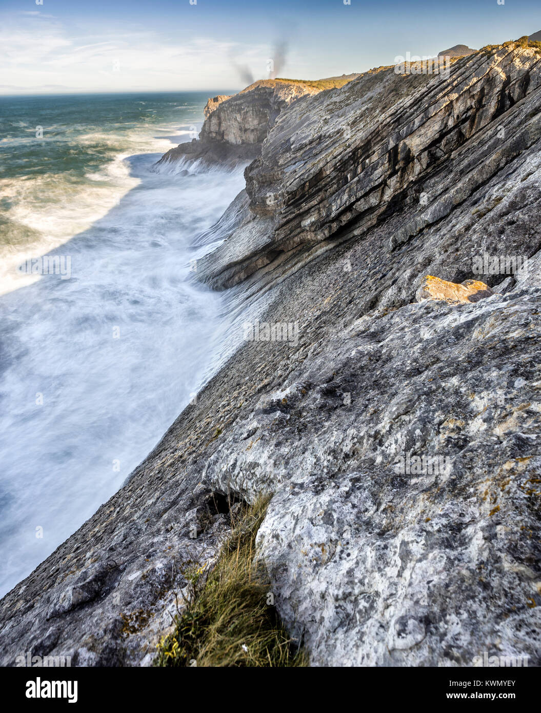 cliff over the sea with geyser on the background Stock Photo