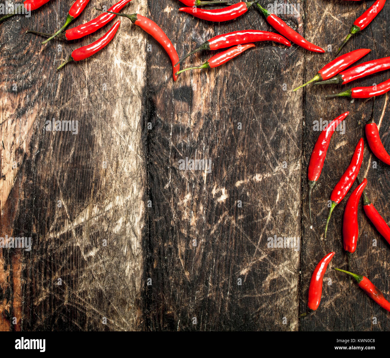 Hot chili peppers. On a wooden background Stock Photo - Alamy