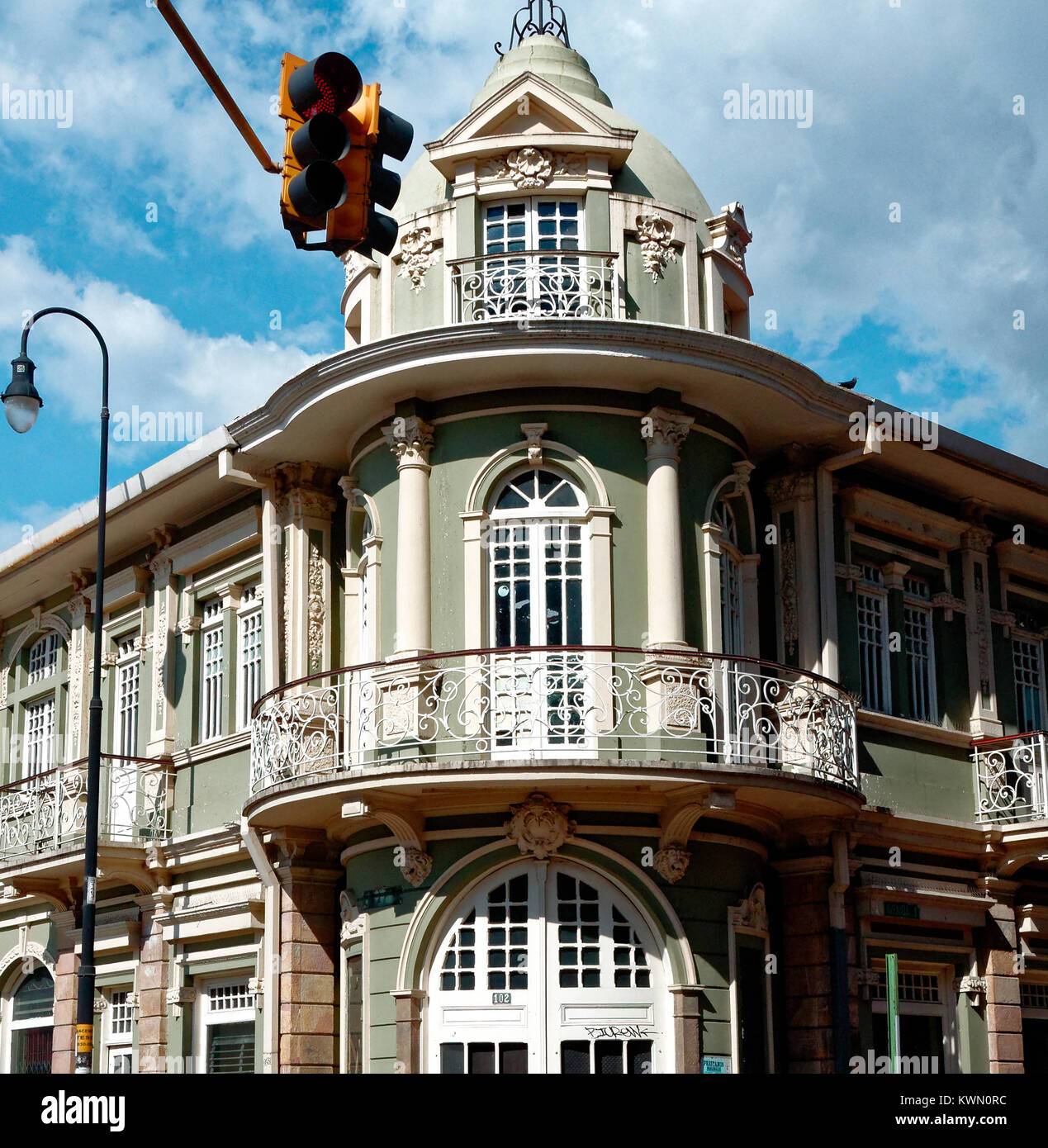 Green corner colonial building with balconies San Jose, Costa Rica Stock Photo
