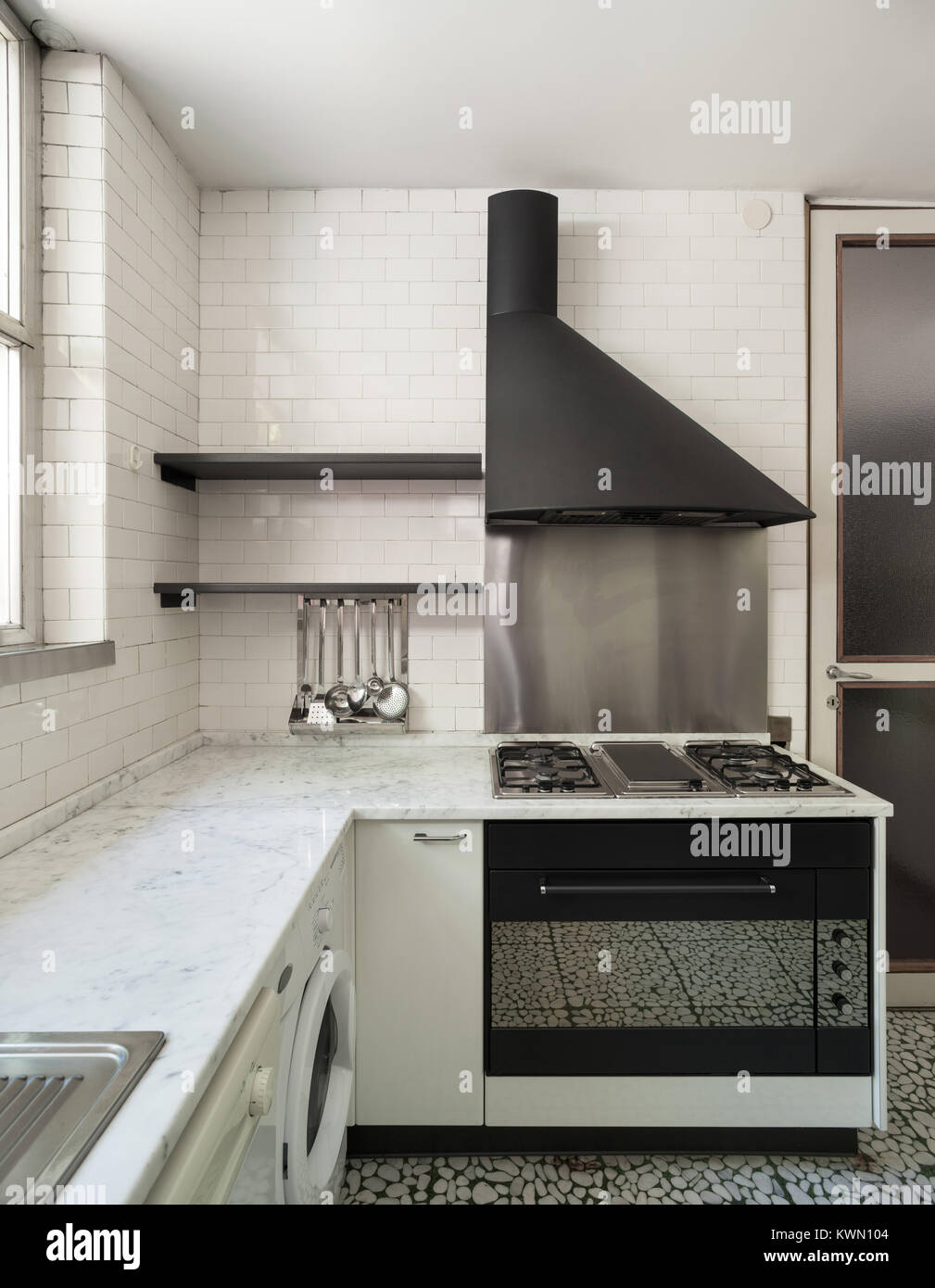 Old domestic kitchen of an apartment, gas stove with hood Stock Photo