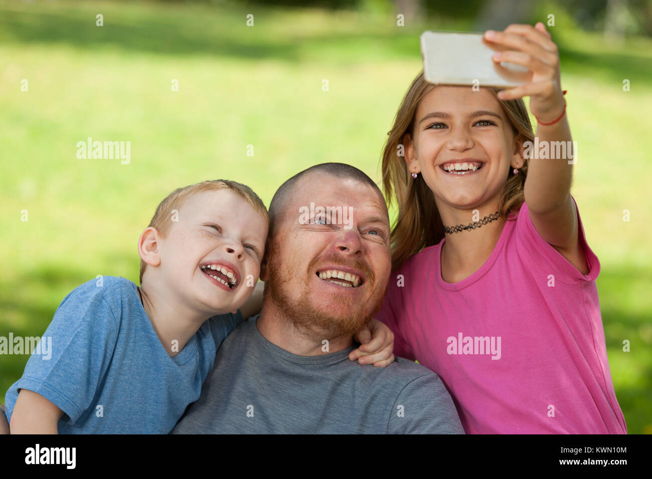 Disabled father doing selfie with children. Stock Photo