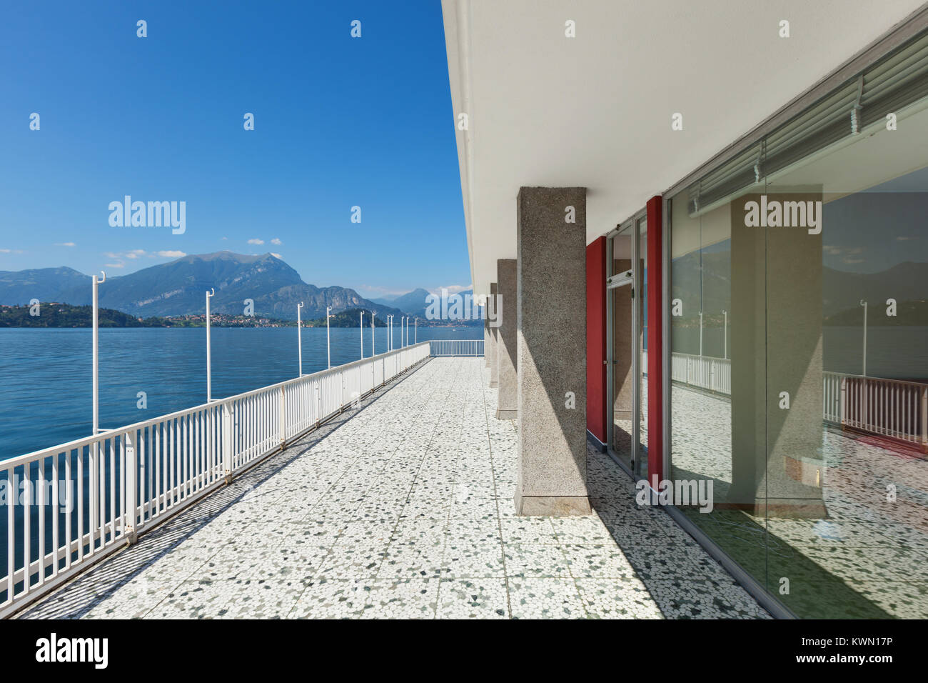 Panoramic view from the balcony of an old penthouse, lake and mountains ...