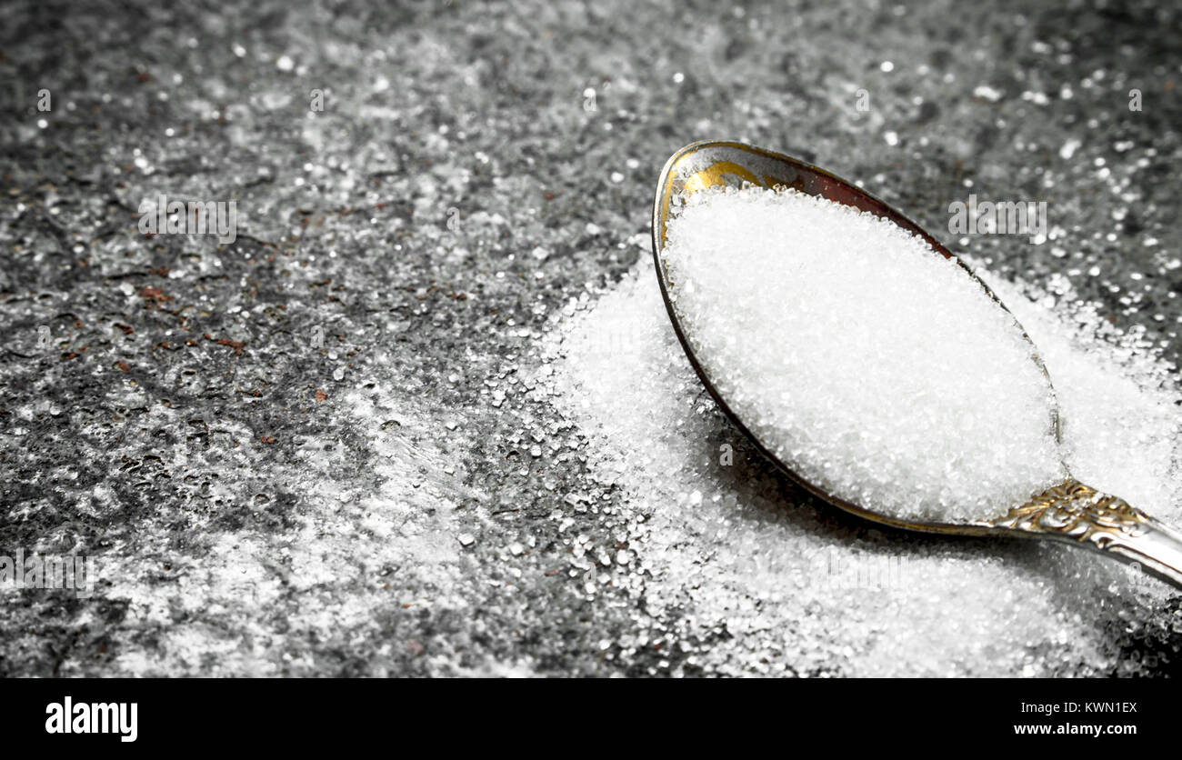 Sugar in a teaspoon. On a rustic background Stock Photo Alamy
