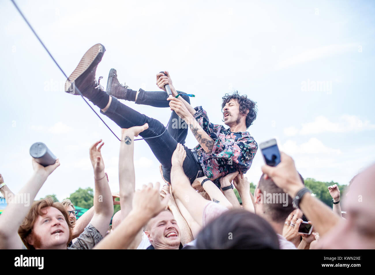 The English hard rock band Turbowolf performs a live concert at the Summer Stage at the Barclaycard British Summer Time festival 2014 at Hyde Park, London. Here vocalist Chris Georgiadis is crowd surfing at the gig. UK 04.07.2014. Stock Photo