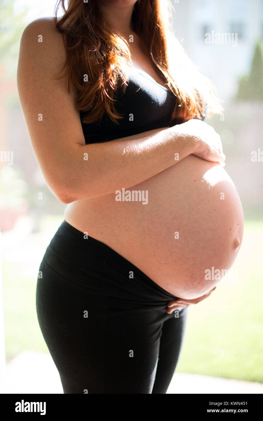 An American mother who is eight months pregnant. Stock Photo