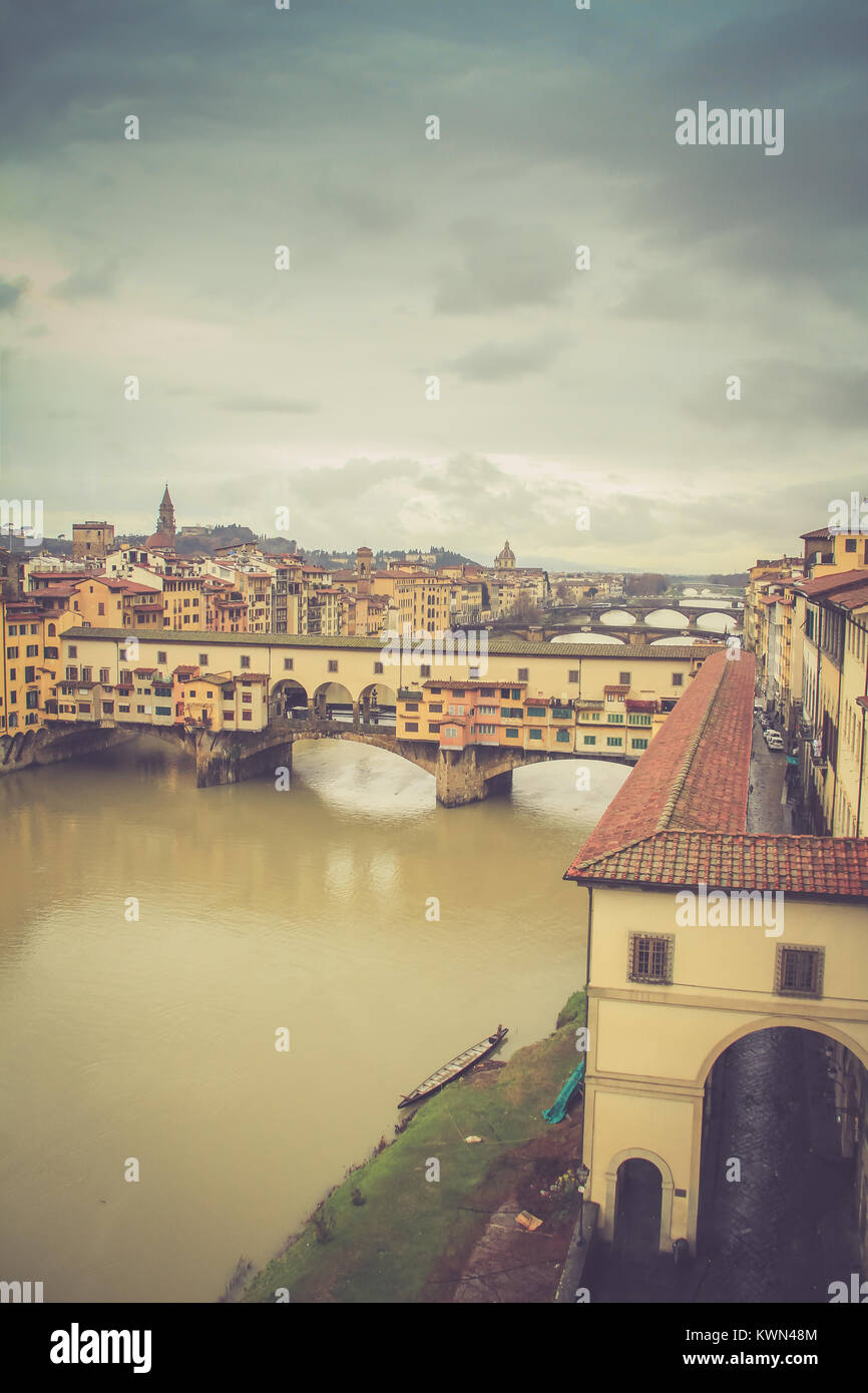 Ponte Vecchio bridge over Arno River with dark cloudy sky background in Florence,Tuscany, Italy Stock Photo