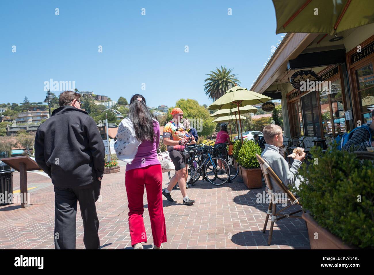 Cyclists, tourists and locals walk through downtown Tiburon, California on a sunny day, August 7, 2016. Stock Photo