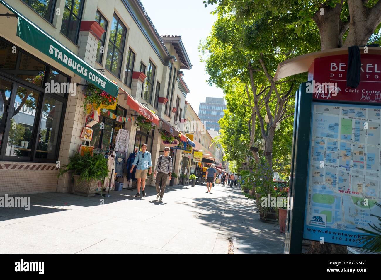 Two people walk down a trendy section of Center Street, near UC Berkeley in downtown Berkeley, California, July 14, 2017. Stock Photo