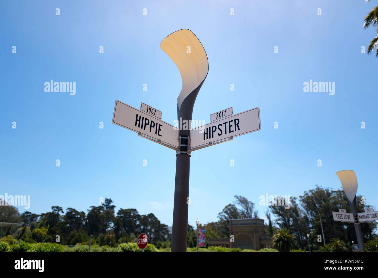 A mock street sign reads 1967 Hippie, 2017 Hipster, comparing a historical and modern social group within the city, at the De Young art museum in Golden Gate Park, San Francisco, California, July 11, 2017. Stock Photo