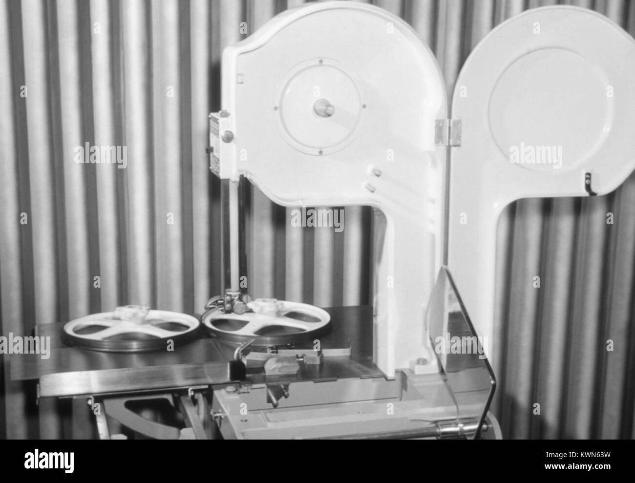 Properly cleaned bandsaw used for cutting meat in a butchers shop on a migrant worker camp, 1975. Image courtesy CDC. () Stock Photo