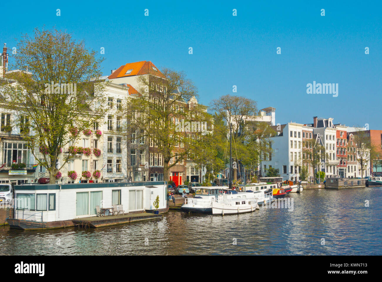 Boats and houseboats, Amstel river, Amsterdam, The Netherlands Stock Photo