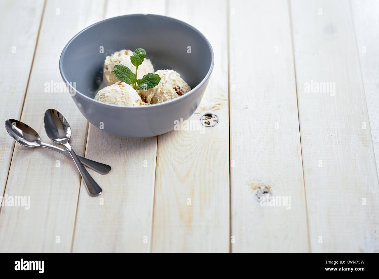 Vanilla ice cream in blue bowl Stock Photo - Alamy