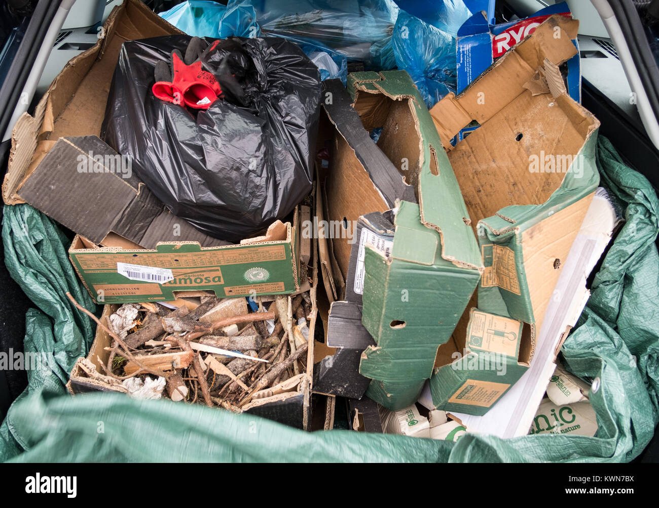 Household rubbish in rear loading area of family estate car ready for recycling. Stock Photo
