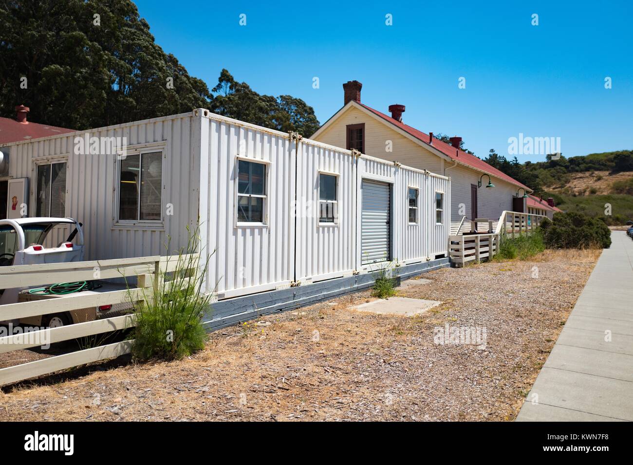 Red-topped, historical buildings with temporary corrugated iron buildings are visible at Fort Baker in the Marin Headlands, Marin County, Sausalito, California, July 19, 2017. Stock Photo